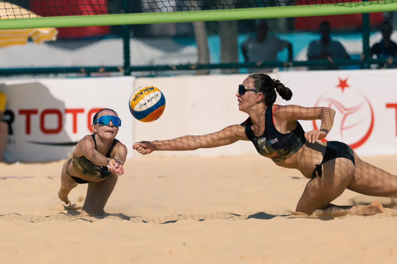 Two players dive for the same ball