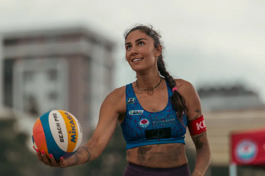 Female player holding the ball, eyes up to the sky